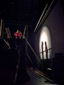 Main characters hugging during a romantic moment on the stage above me (Photo Credit: Zachary Dean)